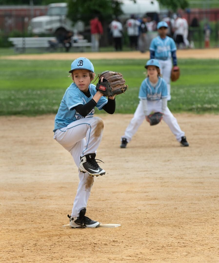 A young baseball player in the middle of a pitch.