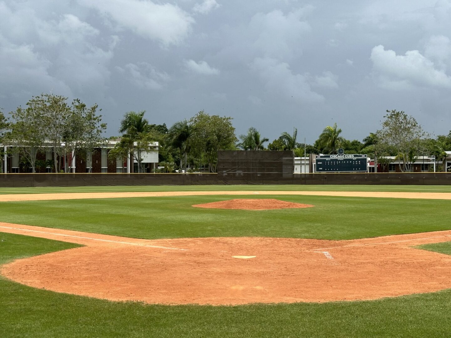 A baseball field with the pitcher 's mound in view.